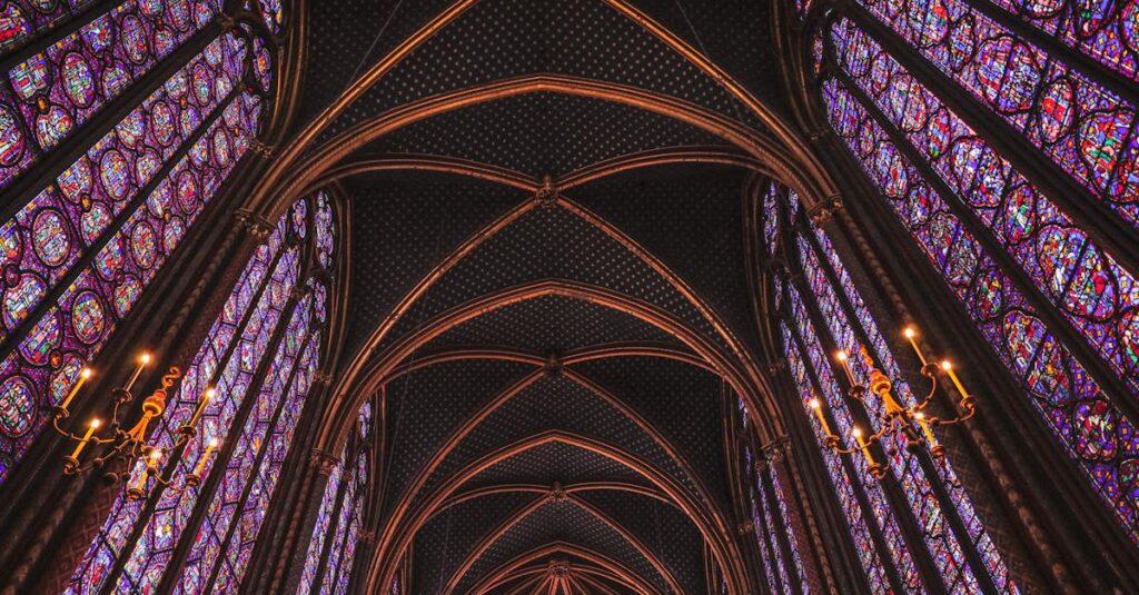 Gothic arches and vibrant stained-glass windows in Sainte-Chapelle, Paris.